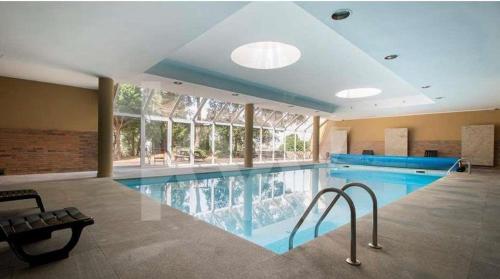 a large swimming pool in a large building at VIVER D'AMOR Oporto Douro River Flat in Vila Nova de Gaia