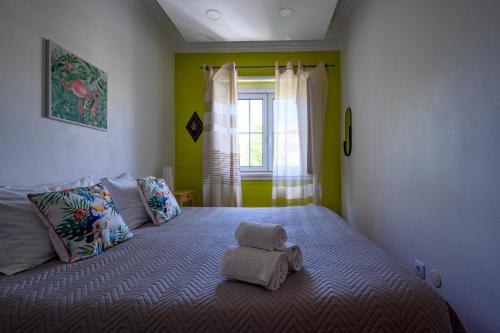 a bedroom with a bed with a stuffed animal on it at Terrace Lisbon Hostel in Lisbon