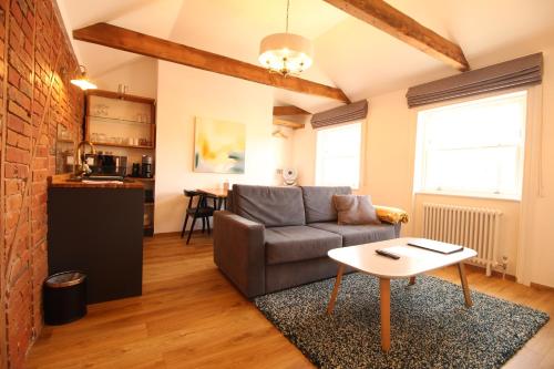 a living room with a couch and a table at Number 8 in Canterbury