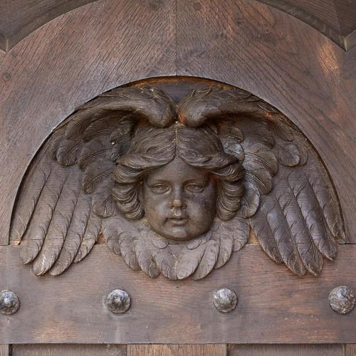 a statue of a woman with wings on a wooden door at Burton Court in Dilwyn