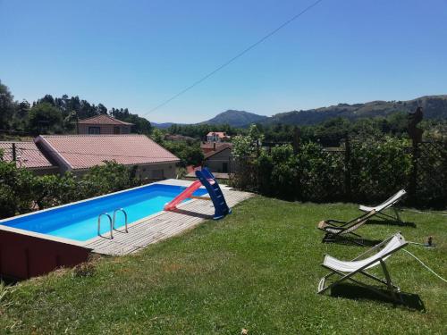 a young boy playing with a red ball in a pool at Casa S. Nicolau in Cabeceiras de Basto