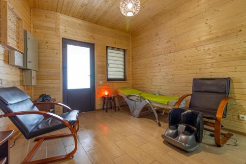 a room with chairs and a table in a wooden cabin at PRAHA in Solotvyno