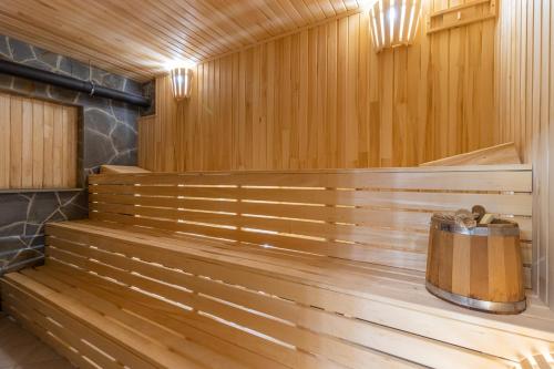 a sauna with wooden benches and a trash can at PRAHA in Solotvyno