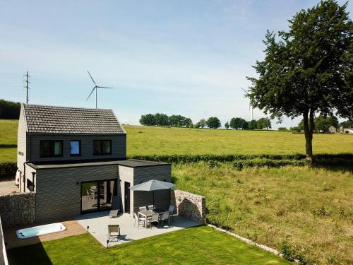 a small house with a view of a field at La Grange du Logis in Waimes