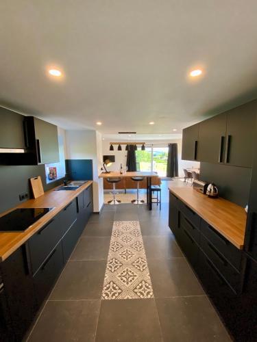 a kitchen with wooden counter tops and a dining room at La Grange du Logis in Waimes