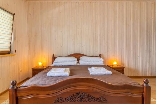a bedroom with a large bed with two towels on it at PRAHA in Solotvyno