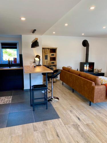 a living room with a couch and a table at La Grange du Logis in Waimes