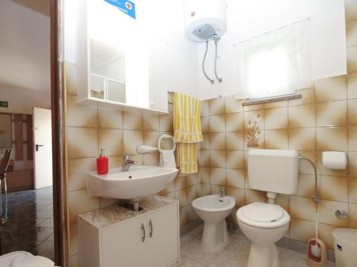 a bathroom with a toilet and a sink at House Vodnjan 2106 in Vodnjan