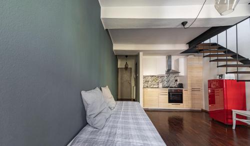 a living room with a bed and a red refrigerator at Sophia's Loft in Parma
