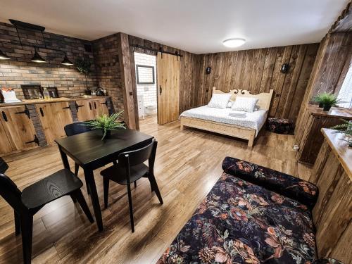 a living room with a table and a couch at Apartamenty Góralski DACH NAD GŁOWĄ in Poronin