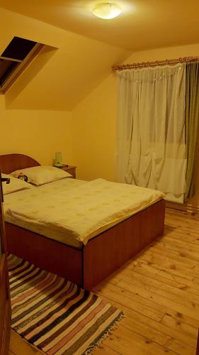 a bedroom with a bed and a window at Feher Cabana in Sovata
