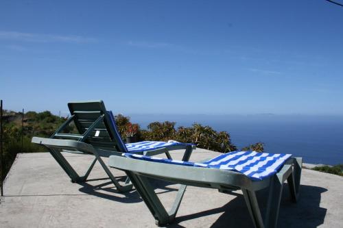 a pair of beach chairs sitting on a ledge at Inés in Tijarafe