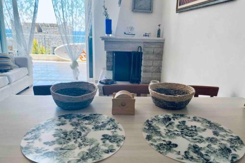 two baskets sitting on a table in a living room at Bella Viky in Mavrovoúnion
