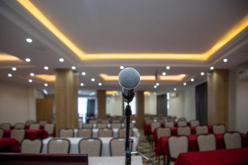 a microphone in the middle of a room with chairs at Aselefech Merga Hotel and Spa in Addis Ababa