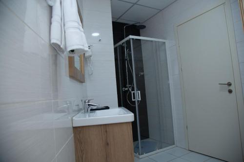 a bathroom with a sink and a shower at Aselefech Merga Hotel and Spa in Addis Ababa