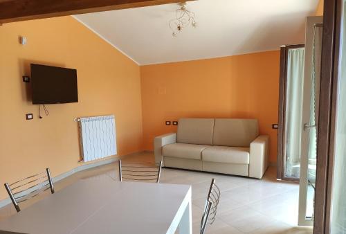 a living room with a couch and a tv at DA ELENA in Castel di Sangro