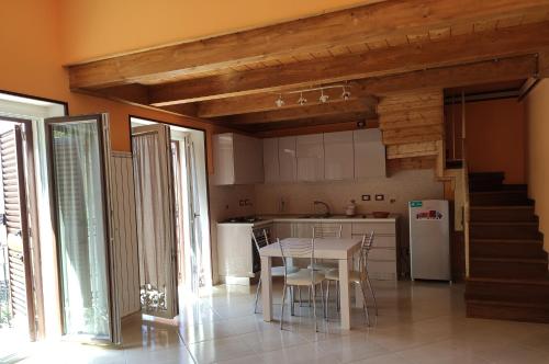 a kitchen with a table and a refrigerator at DA ELENA in Castel di Sangro