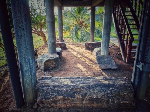 a stairway leading to a building with stone steps at Sarada lagoon view cabana in Hungama