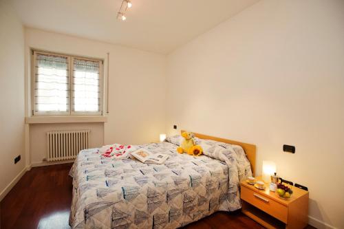 a bedroom with a bed with a stuffed animal on it at Appartamento Aurora in Riva del Garda