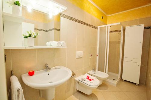 a bathroom with a sink and a toilet at Appartamento Aurora in Riva del Garda