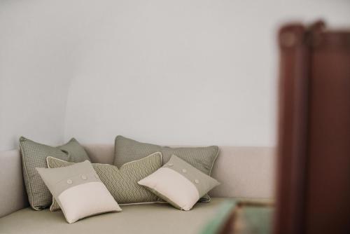 a bunch of pillows sitting on a couch at VENTITRÈ- House of Apulia Mea in Alberobello