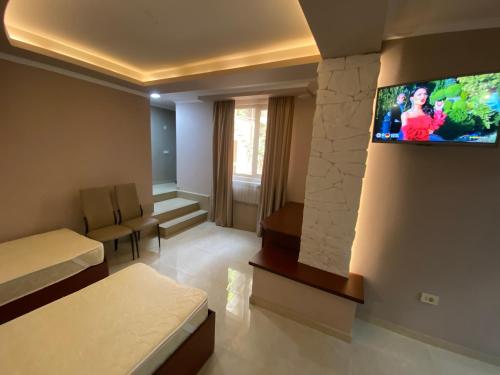 a hotel room with a tv on a wall at Your Home (YH) in Yerevan