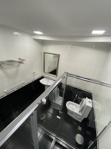 a bathroom with two toilets and a sink and a mirror at Your Home (YH) in Yerevan