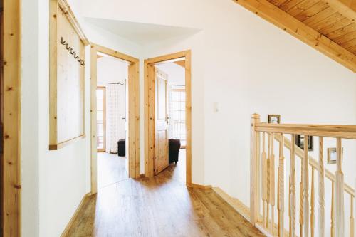 a living room with white walls and wooden floors at Andis Almdorf in Sölden