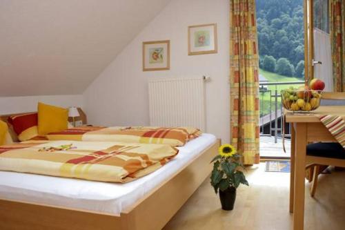 a bedroom with two beds and a table and a window at Haus Sonnbühel in Brand