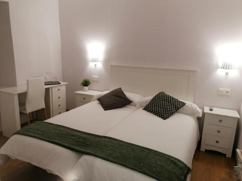 a bedroom with a large white bed with two pillows at Casa Perazancas At 34-49 in Perazancas