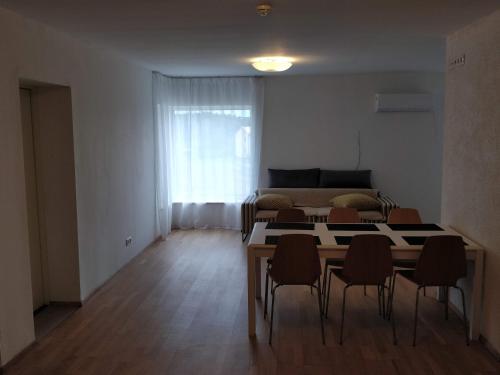a living room with a table and chairs and a bed at Laheveere in Värska