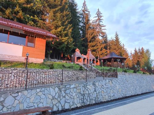 a building and a stone wall next to a building at Casa Sofia Bucovina in Ciumîrna