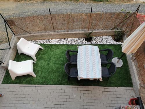 an overhead view of a table and chairs on a lawn at GINEVRA in La Spezia