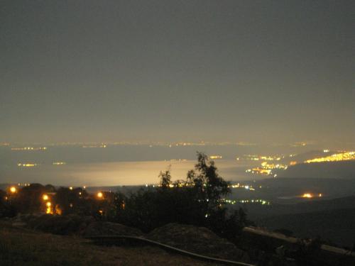 a view of a city at night with lights at Honny - Boutique Hotel in Amirim