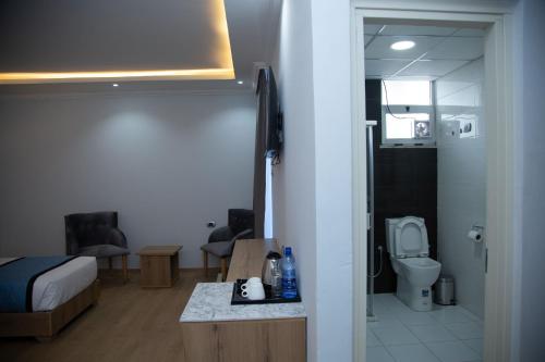 a small bathroom with a bed and a toilet at Aselefech Merga Hotel and Spa in Addis Ababa