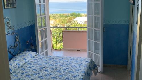 a bedroom with a bed and a view of the ocean at Villa Annina B&B in Tropea