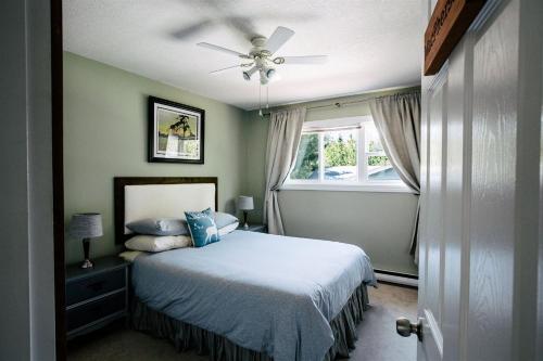 a bedroom with a bed and a ceiling fan at Alpenrose Revelstoke Bed & Breakfast in Revelstoke