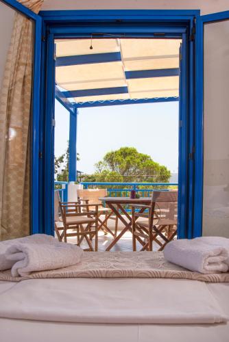 a room with a view of a patio with a table at Kanellis Studios in Avlemonas
