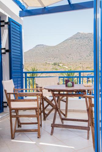 a table and chairs on a balcony with a view at Kanellis Studios in Avlemonas