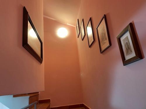 a hallway with four pictures on the wall at Centro estivo Il Piccolo Paradiso in Sonnino