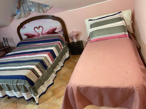 a bedroom with two beds with a blanket on it at Centro estivo Il Piccolo Paradiso in Sonnino