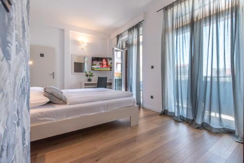 a bedroom with a bed and a large window at Apartments Amigos in Podstrana