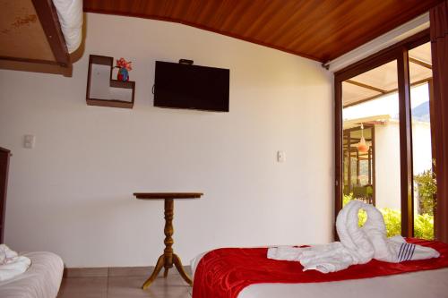 a bedroom with a bed with a stuffed animal on it at Posada Tierra Viva in Villa de Leyva