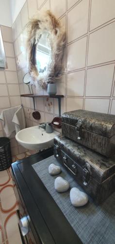 a bathroom with two suitcases on a counter and a sink at Villa Thalia in Marinići