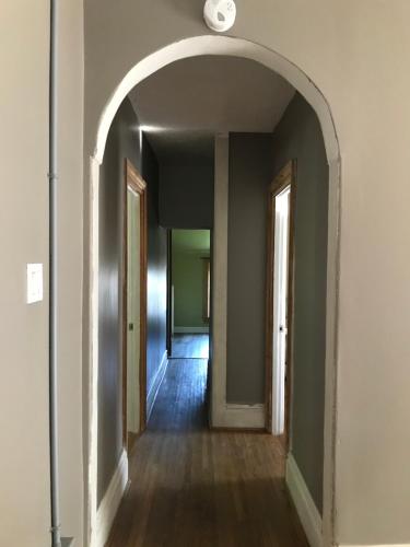 an empty hallway with an archway in a building at WHITE SWAN House in Niagara Falls