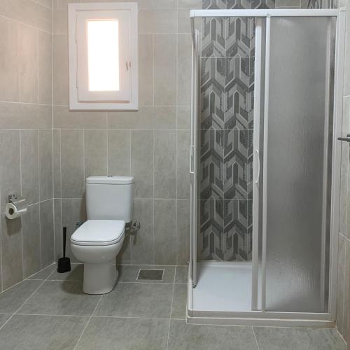 a bathroom with a toilet and a shower at Virginia Beach Standalone Villa in El Alamein
