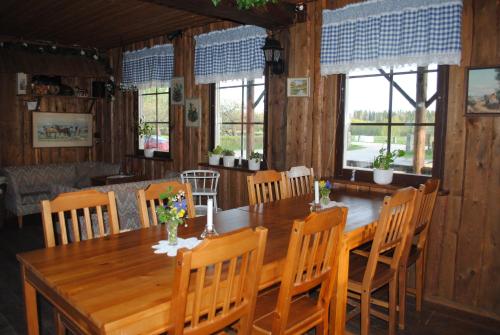 a dining room with a wooden table and chairs at Stall Stråtjära in Stråtjära