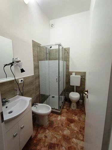 a bathroom with a shower and a toilet and a sink at Domus Cesena in Cesena