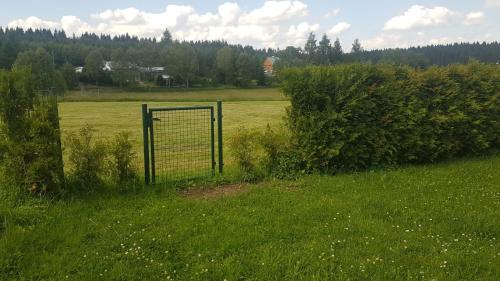 an open field with a gate in the grass at Ferienhaus Kühnhaide im Erzgebirge in Kühnhaide