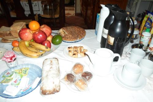 a table topped with plates of bread and fruit at La Casona de Susana in Colón